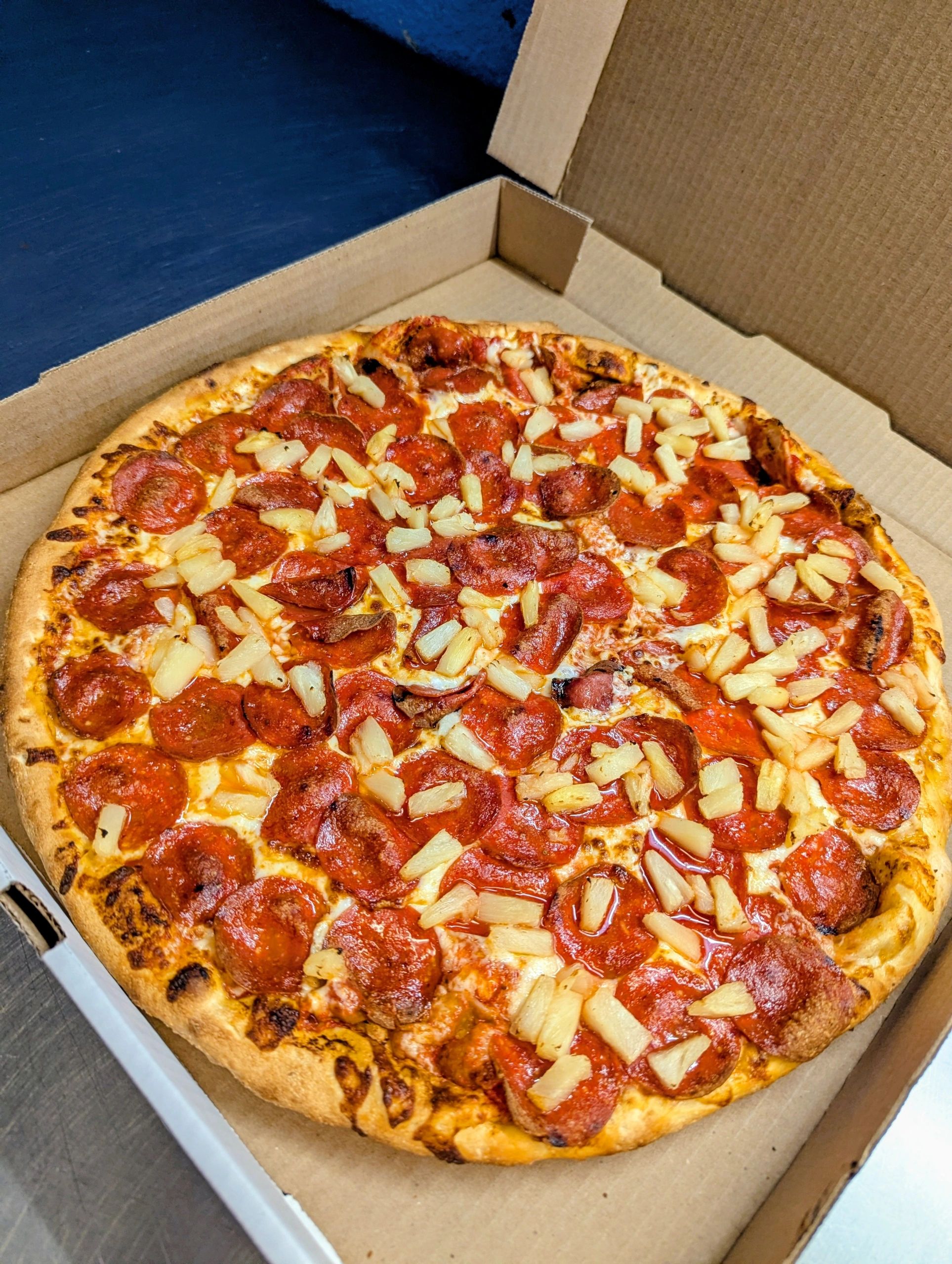 Pepperoni pizza in delivery box