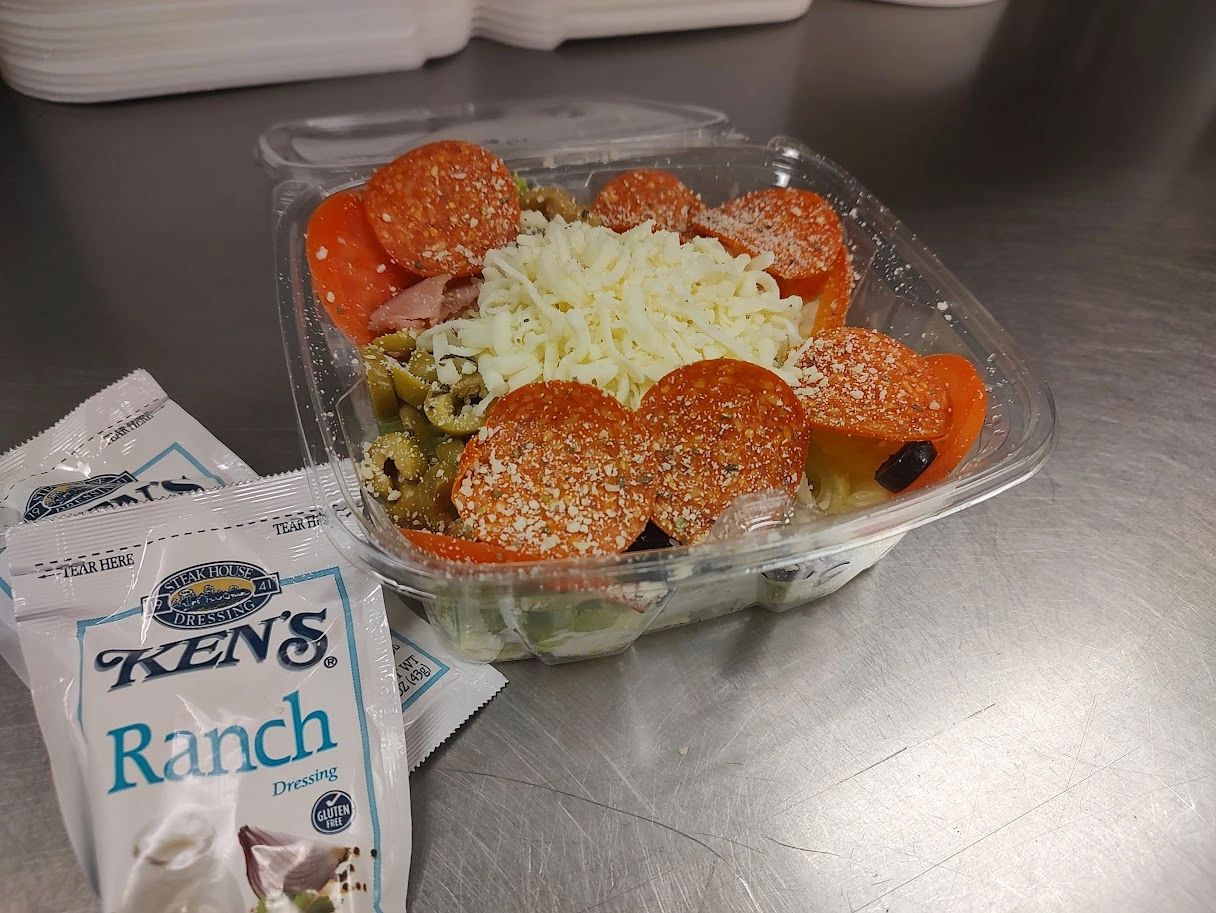 Pepperoni salad in takeout container