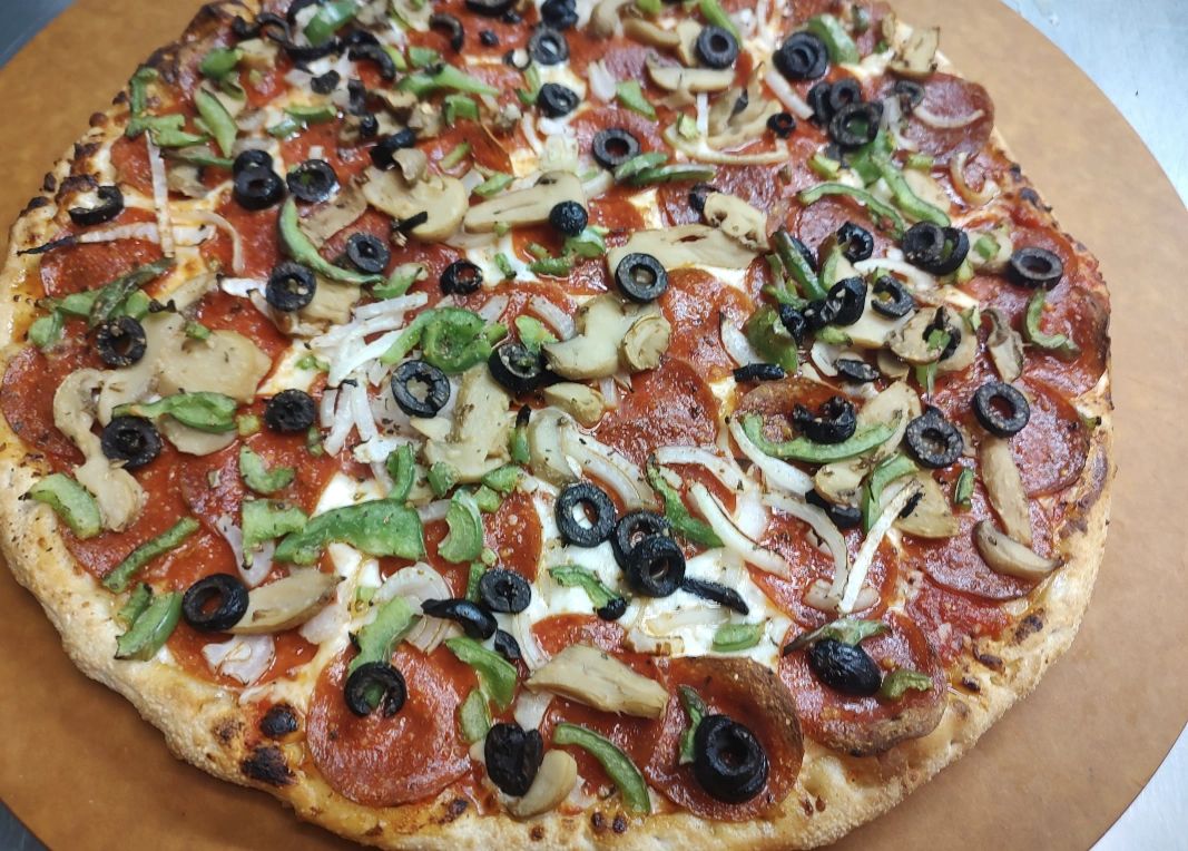 Pizza with pepperoni olives mushrooms